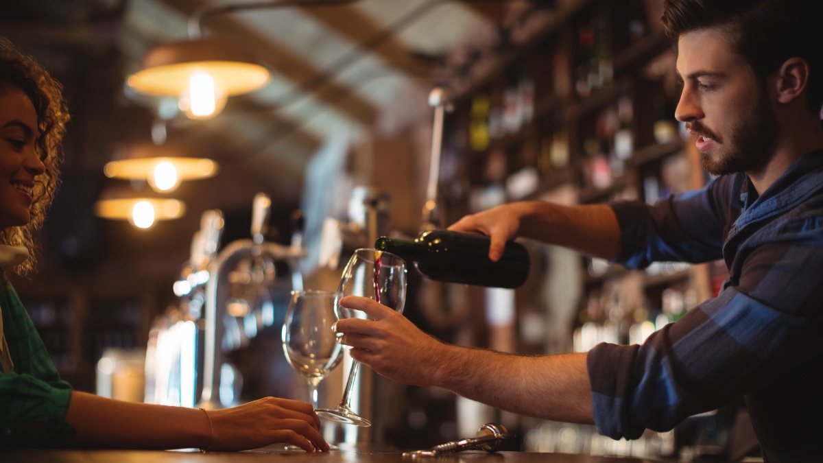 barman pouring wine