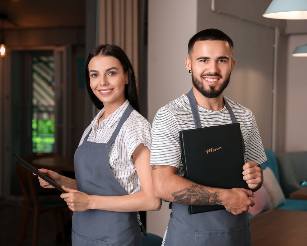 restaurant team holding menus