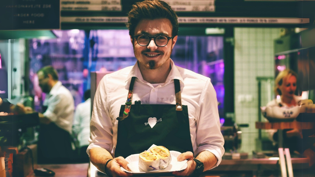 young waiter in restaurant